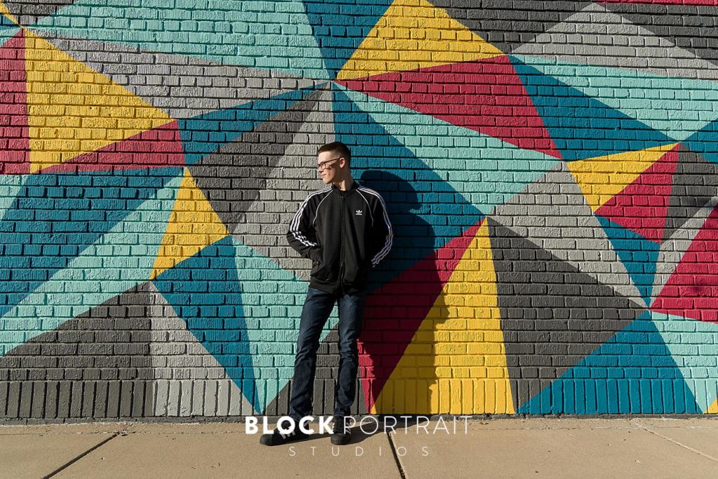 Senior Picture in front of colorful Mural at Block Portrait Studios