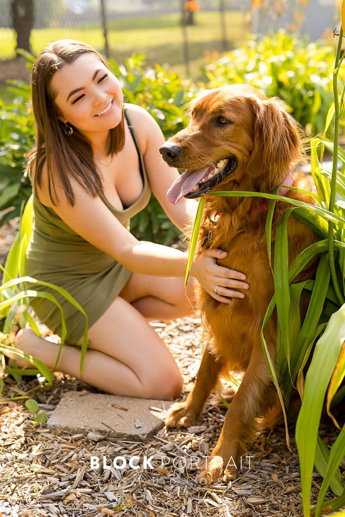 High School Senior girl crouching next to dog