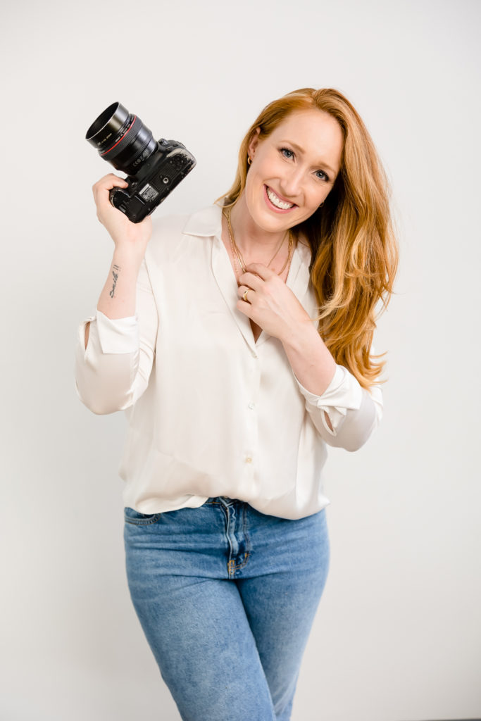 photographer mentor jeannine marie with camera offering photographers business coaching