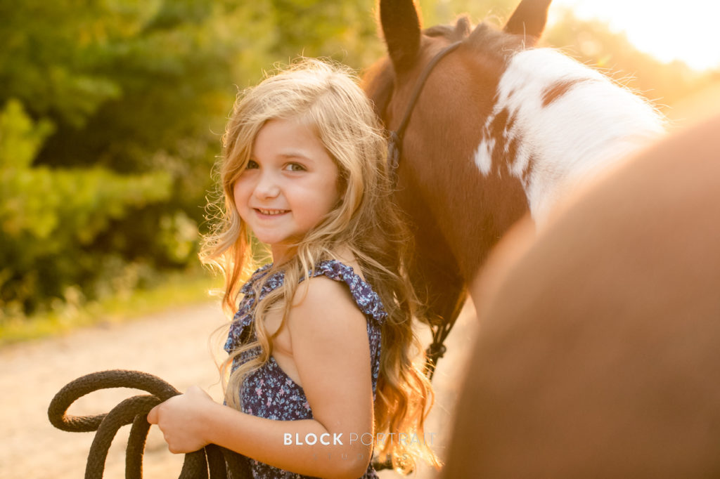 Photo of little girl and her horse enjoying the ultimate summer by Block Portrait Studios