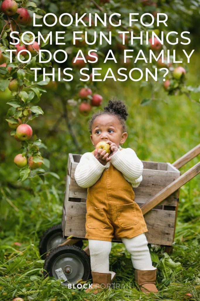 picture of little girl eating an apple in Minnesota doing ultimate fall family activities by Block Portrait Studios