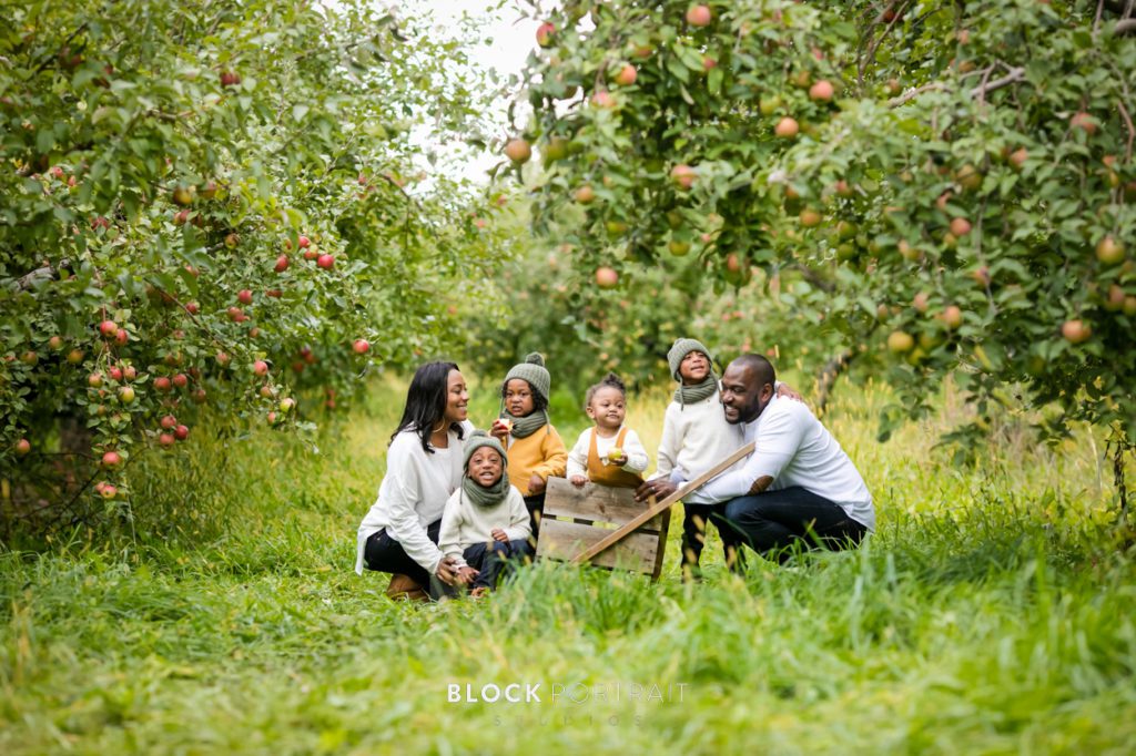 Family picture at Minnetonka Orchards participating in fall family activities taken by Block Portrait Studios