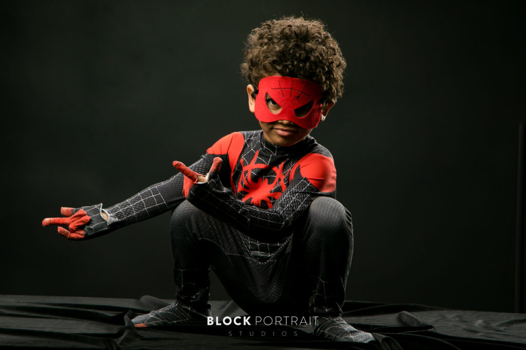 Picture of little boy in superhero costume in St. Paul studio by Block Portrait Studios
