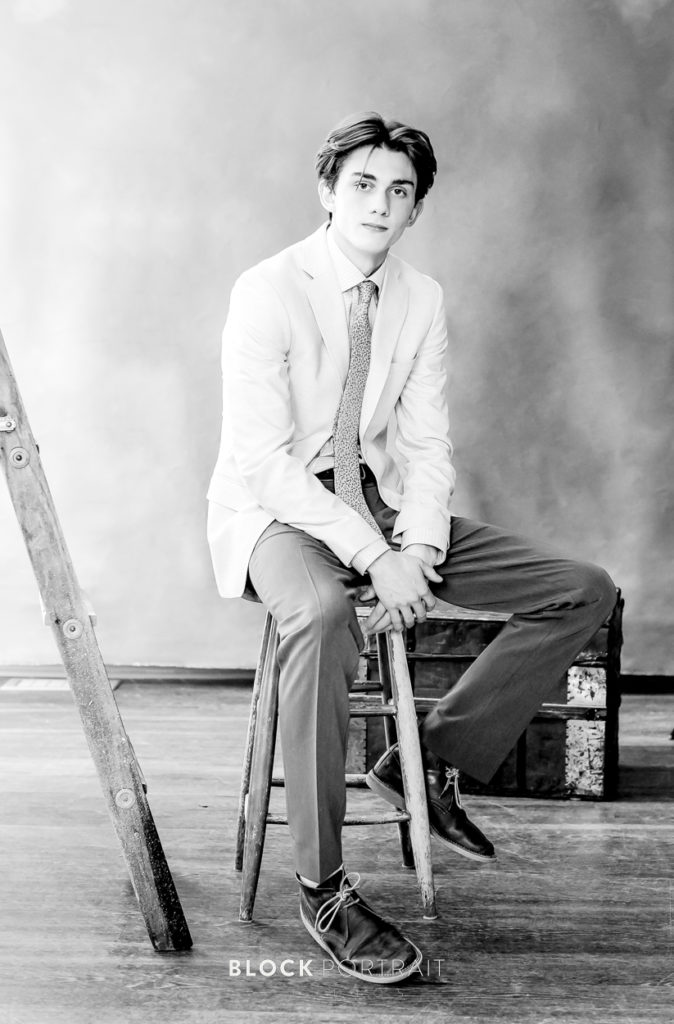Black and white portrait of senior boy in Saint Paul studio by Block Portrait Studios