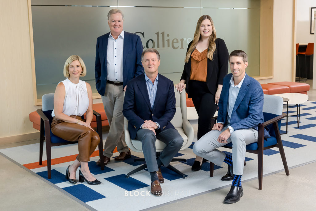 Business team posing for Business Team portraits in their Minneapolis office by Block Portrait Studios