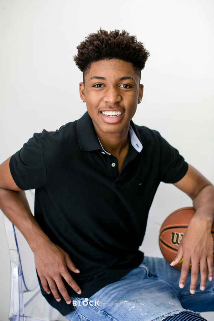 Photo of Senior boy with his basketball in st paul studio by Block Portrait Studios