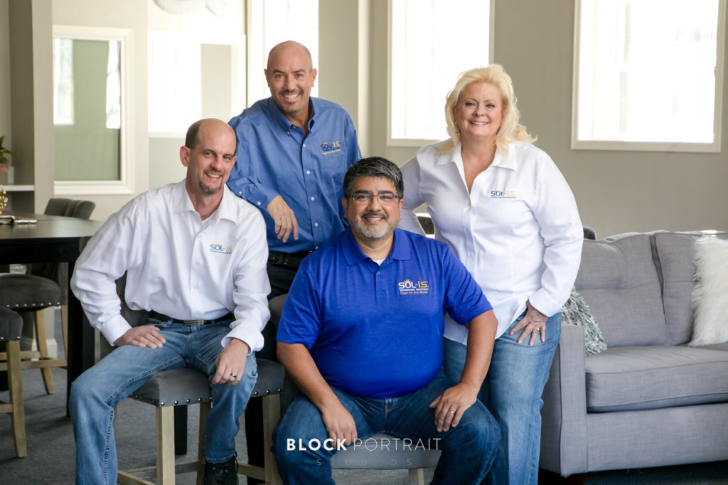 Team of four people posing for branding portrait