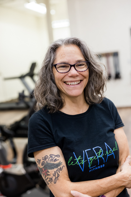 Small business owner posing in her fitness studio in St. Paul by Twin Cities photographer Block Portrait Studios